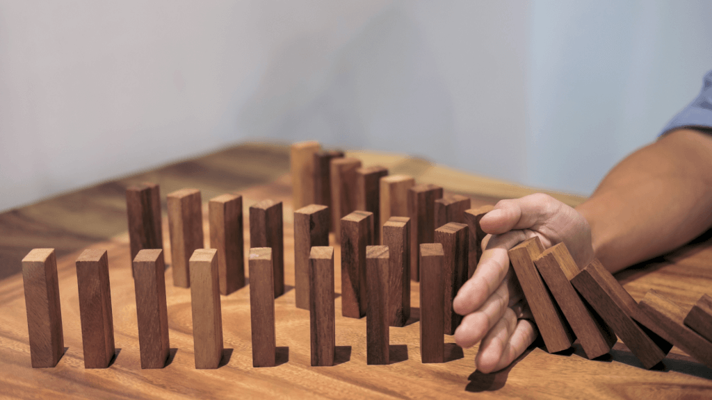 Understanding the Third Line of Defence Graphic An image of a hand separating falling wooden blocks