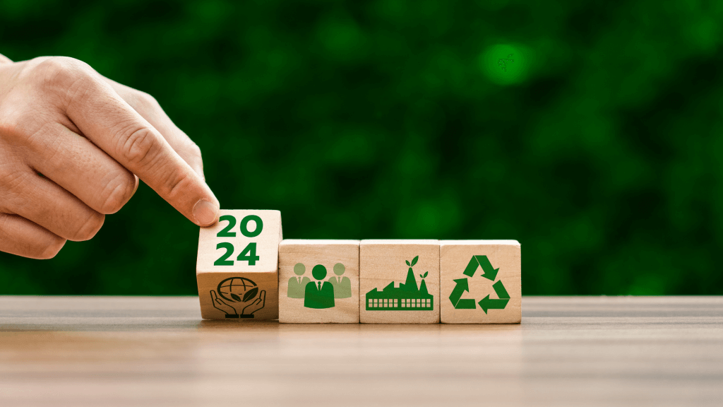 An image showing four blocks with Greenwashing and eco-friendly images, the fourth, being turned by a hand has the year 2024 on it.